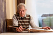 © Denizo - Senior man holding his youth picture and remembering past.