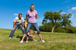 © Kzenon - Family with children playing on a meadow
