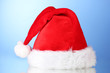 © Africa Studio - Beautiful Christmas hat on a blue background