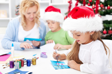 Family making seasonal greeting cards together