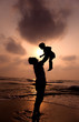 © Tom Wang - the silhouette of happy father and little girl on the beach
