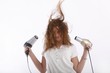 wild young woman with two hairdryer