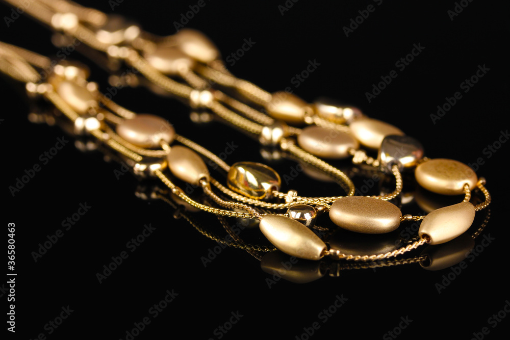 beautiful gold necklace on black background