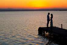 Couple Sunset Profile Back Light In Orange Sea