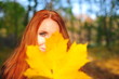 red-haired woman with a yellow leaf