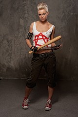 Wall Mural - Punk girl with a baseball bat against grey background.