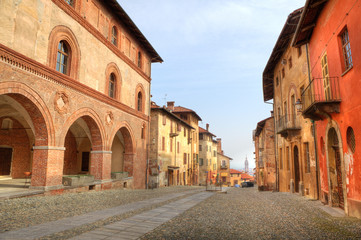 Wall Mural - Paved street among historic houses in Saluzzo, Italy.