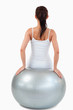 © WavebreakmediaMicro - Portrait of a brunette woman working out with a ball