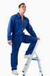 © WavebreakmediaMicro - Portrait of a mechanic climbing on a stool