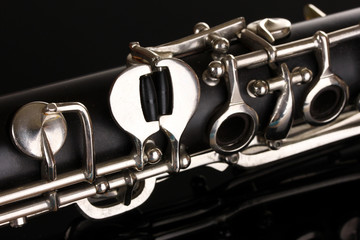 Canvas Print - close up detail of clarinet on black background