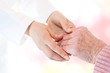 © Tierney - Doctor holding senior lady's hand