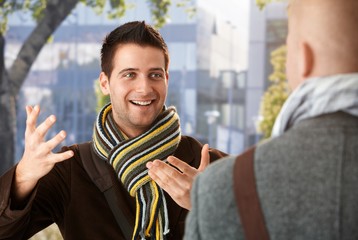 Wall Mural - Cheerful guy gesturing to friend