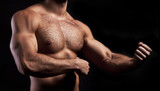 body of muscular man on black background