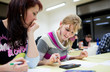 © lightpoet - pretty female college student sitting in a classroom