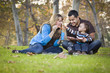 © Andy Dean - Happy Mixed Race Ethnic Family Playing with Bubbles In The Park
