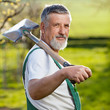 © lightpoet - portrait of a senior man gardening in his garden