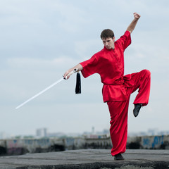 Wall Mural - Wushoo man in red practice martial art