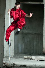 Wall Mural - Wushoo man in red practice martial art