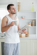 © WavebreakmediaMicro - Portrait of a sports man drinking tea while reading the news