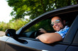 © baranq - Young man in car smiling