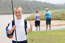 Happy Little Boy Fishing With Grandpa And Brother