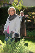 © auremar - young woman helping senior lady in the garden