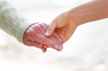 Poster - senior and young holding hands