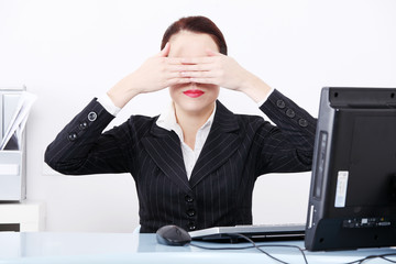 Beautiful business woman hiding her eyes behind hand.