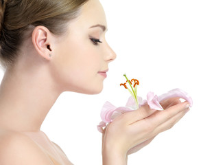 Wall Mural - Profile face of beautiful girl smelling flower