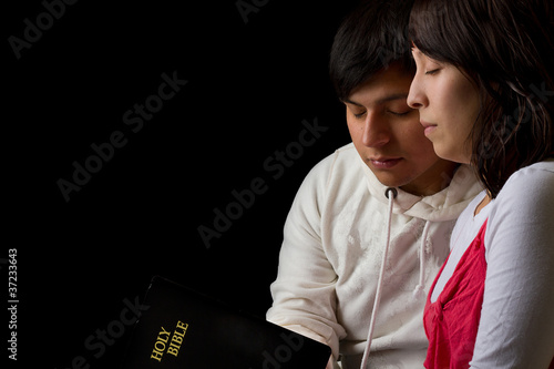 Fotografie, Obraz Hispanic Couple Studying the Bible and Praying