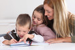 © goodluz - Woman helping kids with homework