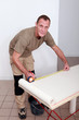 © auremar - Man measuring wallpaper