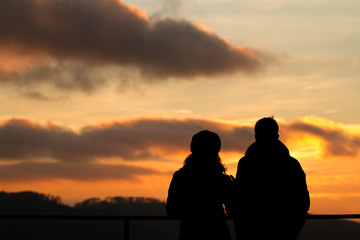 silhouette of couple watching sunset