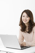 © one - Beautiful asian woman using a laptop computer