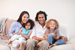 © WavebreakmediaMicro - Cheerful family sitting on the sofa together