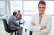 © WavebreakmediaMicro - Smiling marketing manager standing in conference room