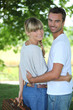 © auremar - Couple with picnic basket in park