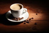 Fototapeta Mapy - cup with coffee and coffee beans on  wooden table