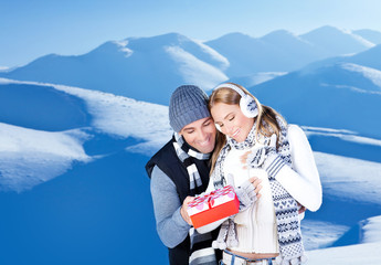 Canvas Print - Happy couple outdoor at winter mountains