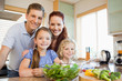 © WavebreakmediaMicro - Family standing behind the kitchen counter