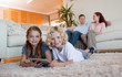 © WavebreakmediaMicro - Brother and daughter using tablet on the carpet