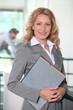 © auremar - Blonde businesswoman holding files