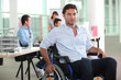 © auremar - Man using a wheelchair in an office environment