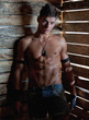 Muscle sexy naked young man near to wooden boards