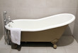 Old style bath tub with metal legs and towel, vintage style