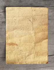 Wall Mural - Crumpled grunge paper on wooden background