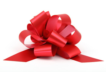 single red ribbon plastic gift bow isolated on white background.