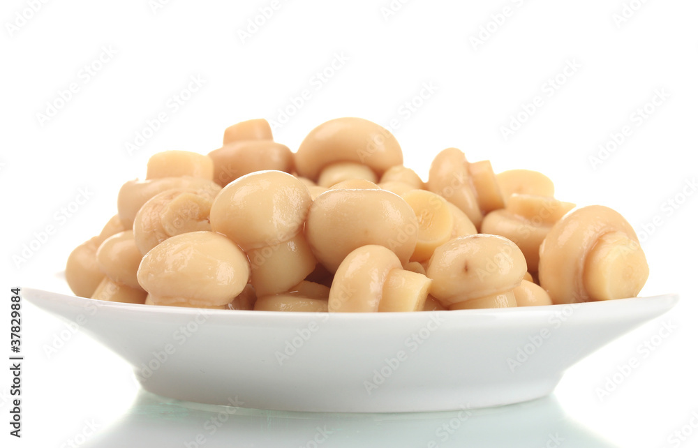 Marinated mushrooms in white saucer isolated on white
