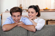 © auremar - Young couple leaning on the back of their sofa