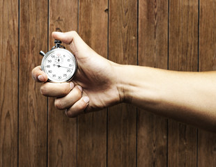 Wall Mural - Hand holding stopwatch